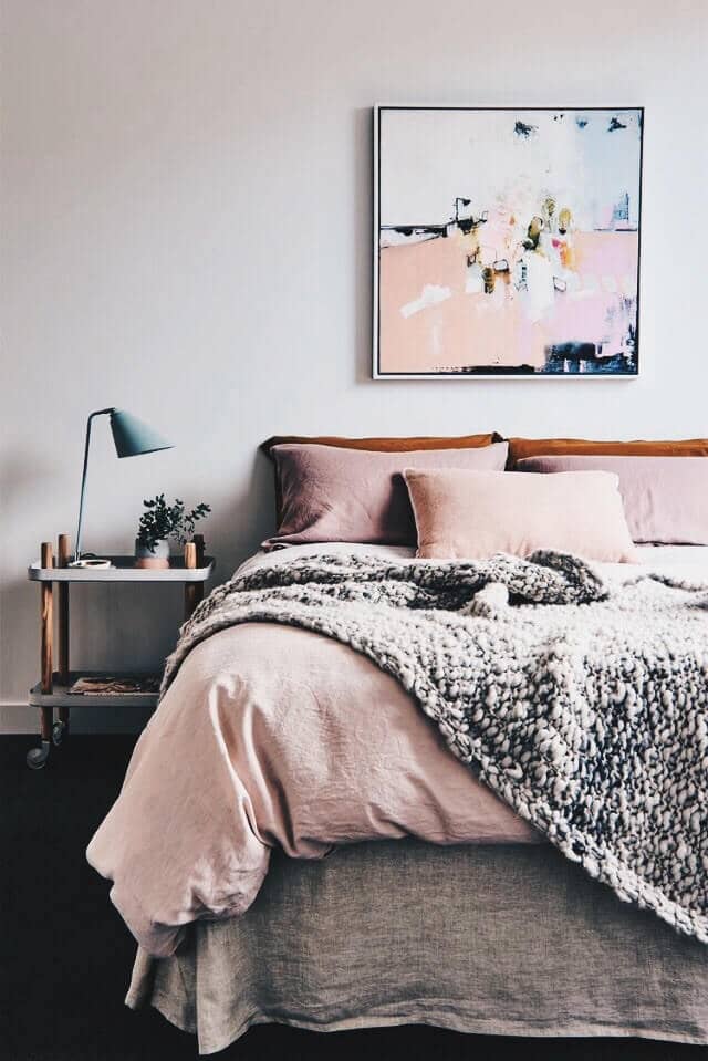 Chunky Gray Blanket With Gray Skirting And Pale Pink Pillows And Sheets