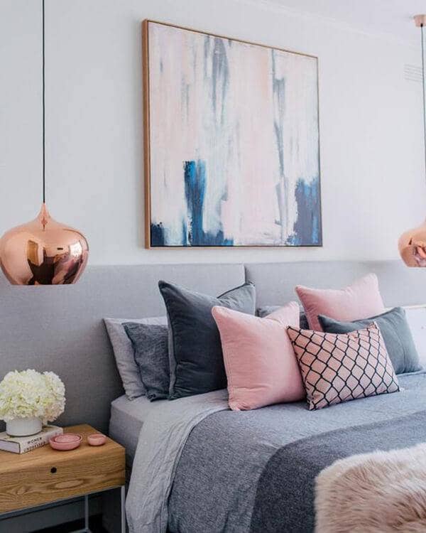 The Copper Tone Lamps Highlight The Pink Accents In The Gray