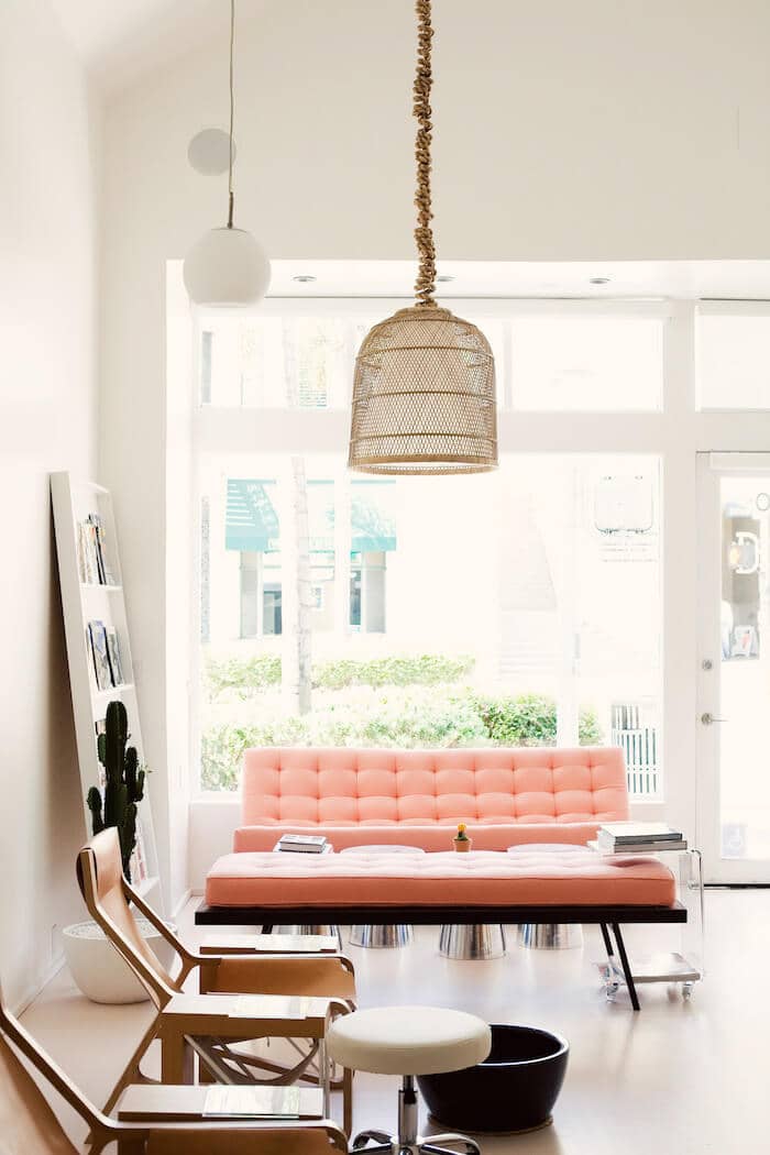 A Pale Salmon Futon Provides Depth To A White Toned Room