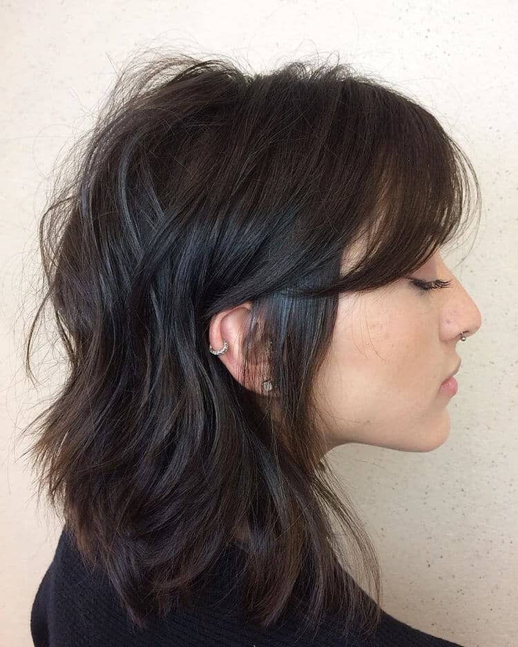 Layered Mid Length Haircut With Long Bangs