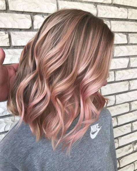 Wavy Dirty Blonde Hairstyle With Rose Gold Highlights