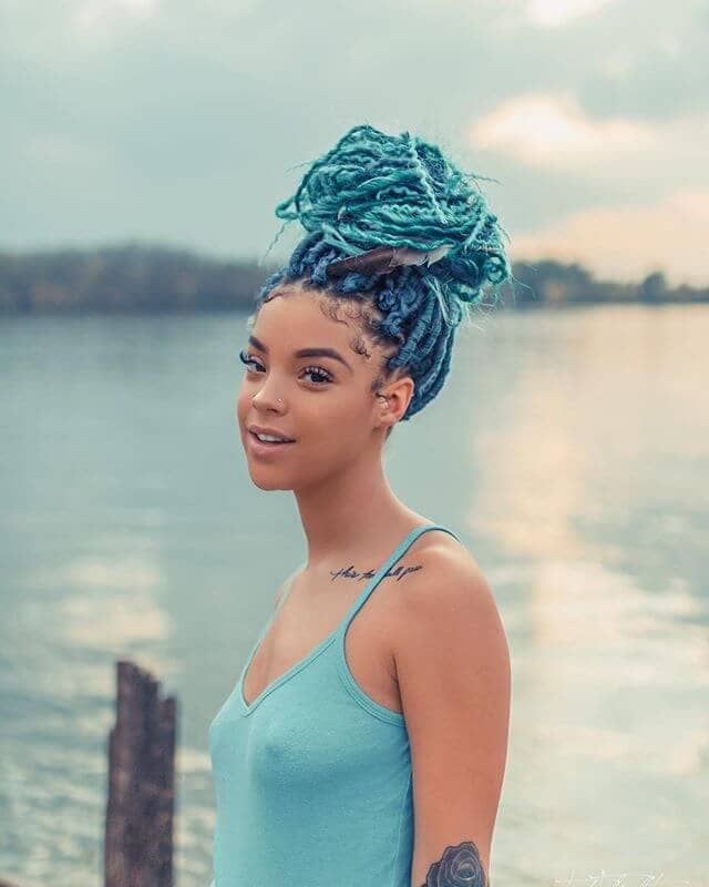  A Colorful Braided Topknot Crochet Hairstyles with Electric Blue Highlights
