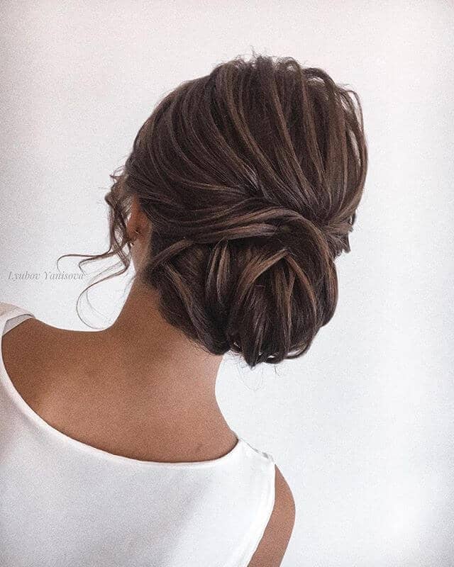 Low Structured Bun With Face-Framing Curls