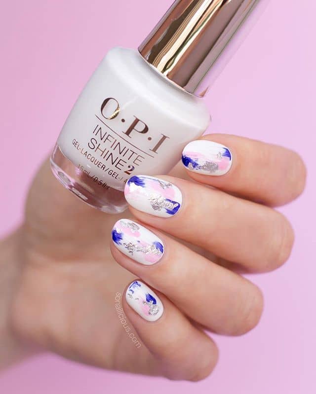 White Nails with Blue and Pink Designs