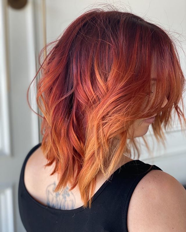  Bright Red and Orange Ombre on Wavy Mid-Length Hair