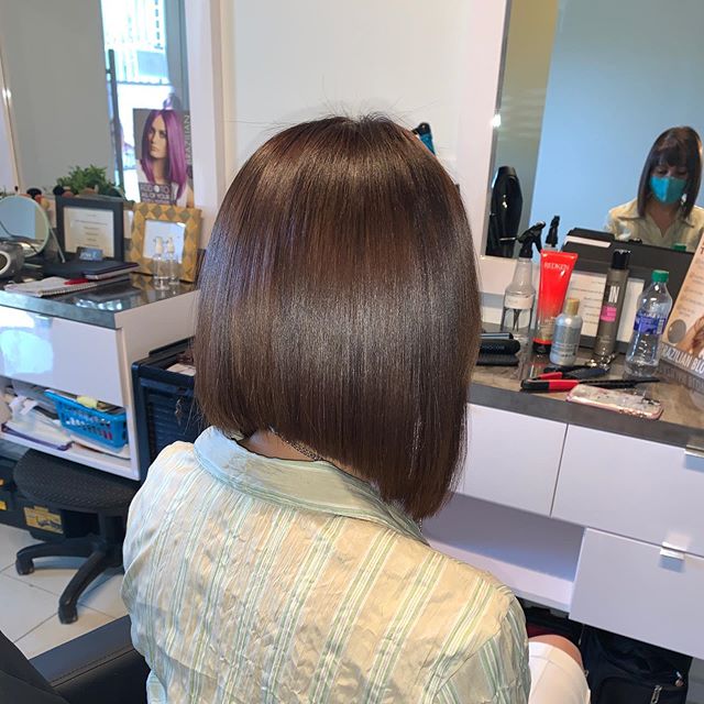 Sleek and Shiny Over-the-Shoulder Asymmetrical Bob