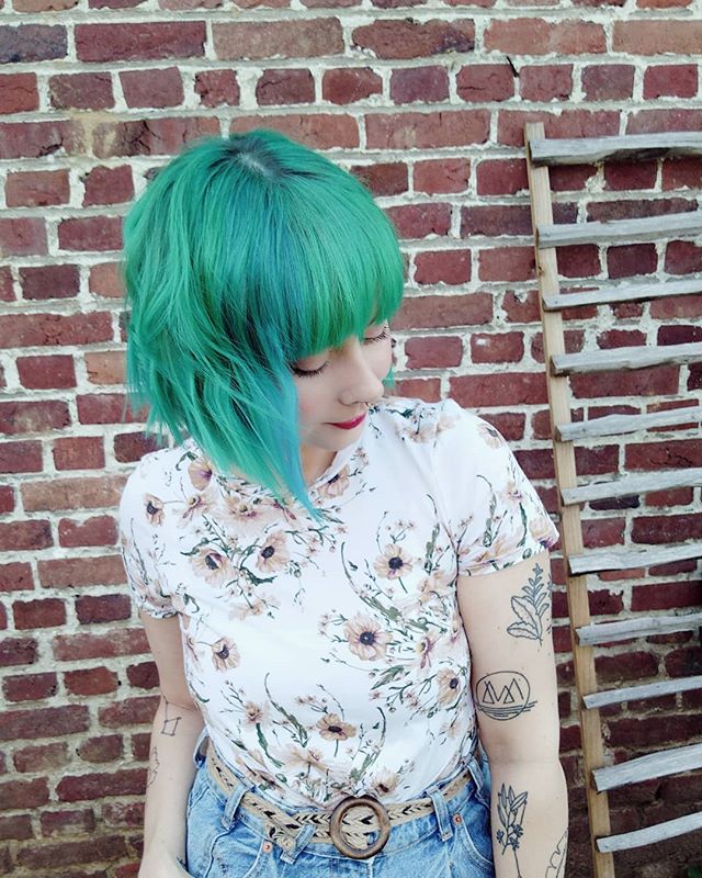 Asymmetrical Cut with Bangs and Blue-Green Color