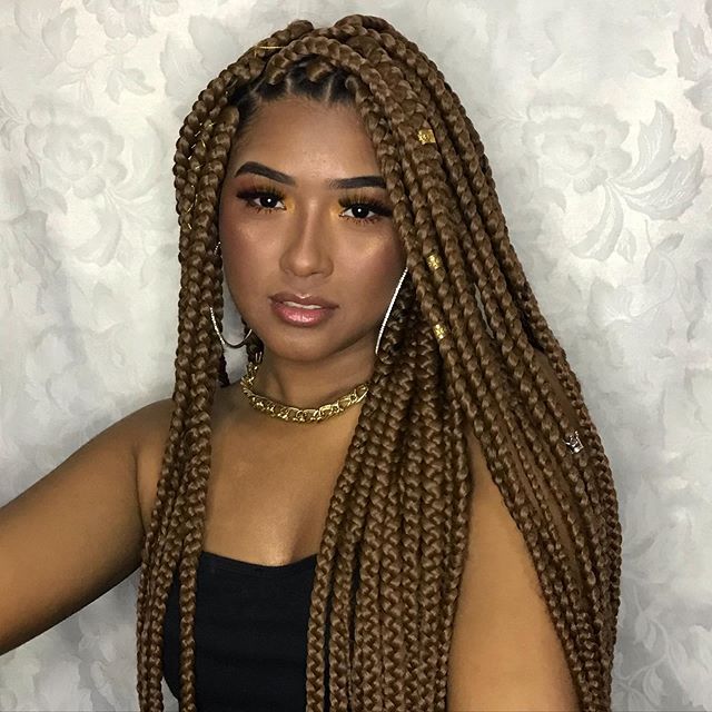 Elegantly done braids with golden beads