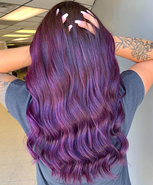 Tumbling Curls Highlighted With the Best Purple Hair Colors