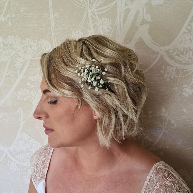 Asymmetrical Waves with Sprigs of White Flowers Wedding Hairstyle for Short Hair
