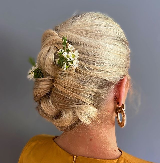  Artfully Twisted Sleek Updo With Floral Accents